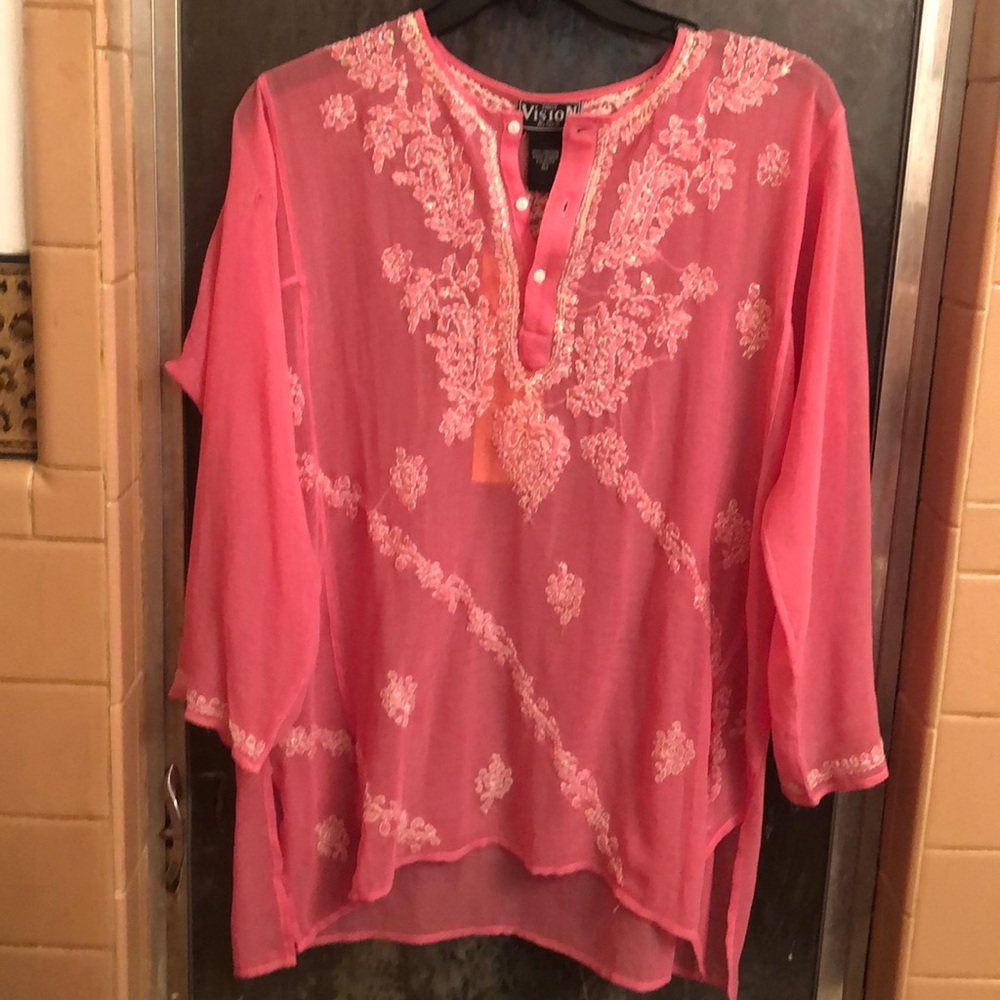 Pretty see through pink blouse with pretty design.